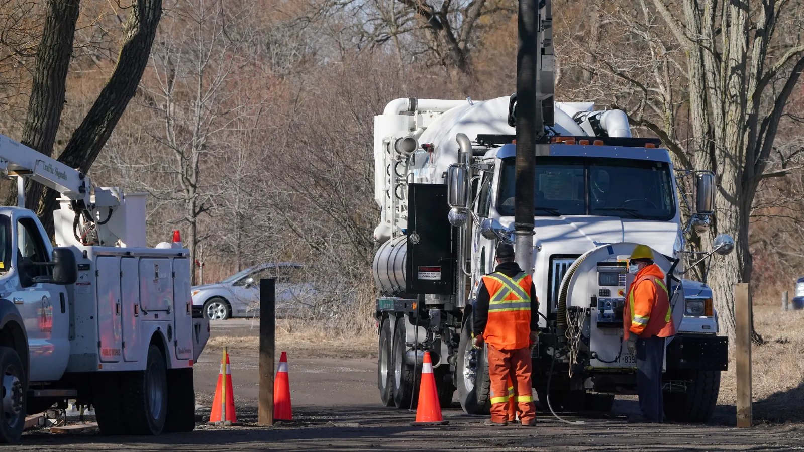 Utility crews and bucket trucks working a roadside job